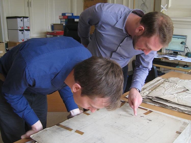Archivists studying a map